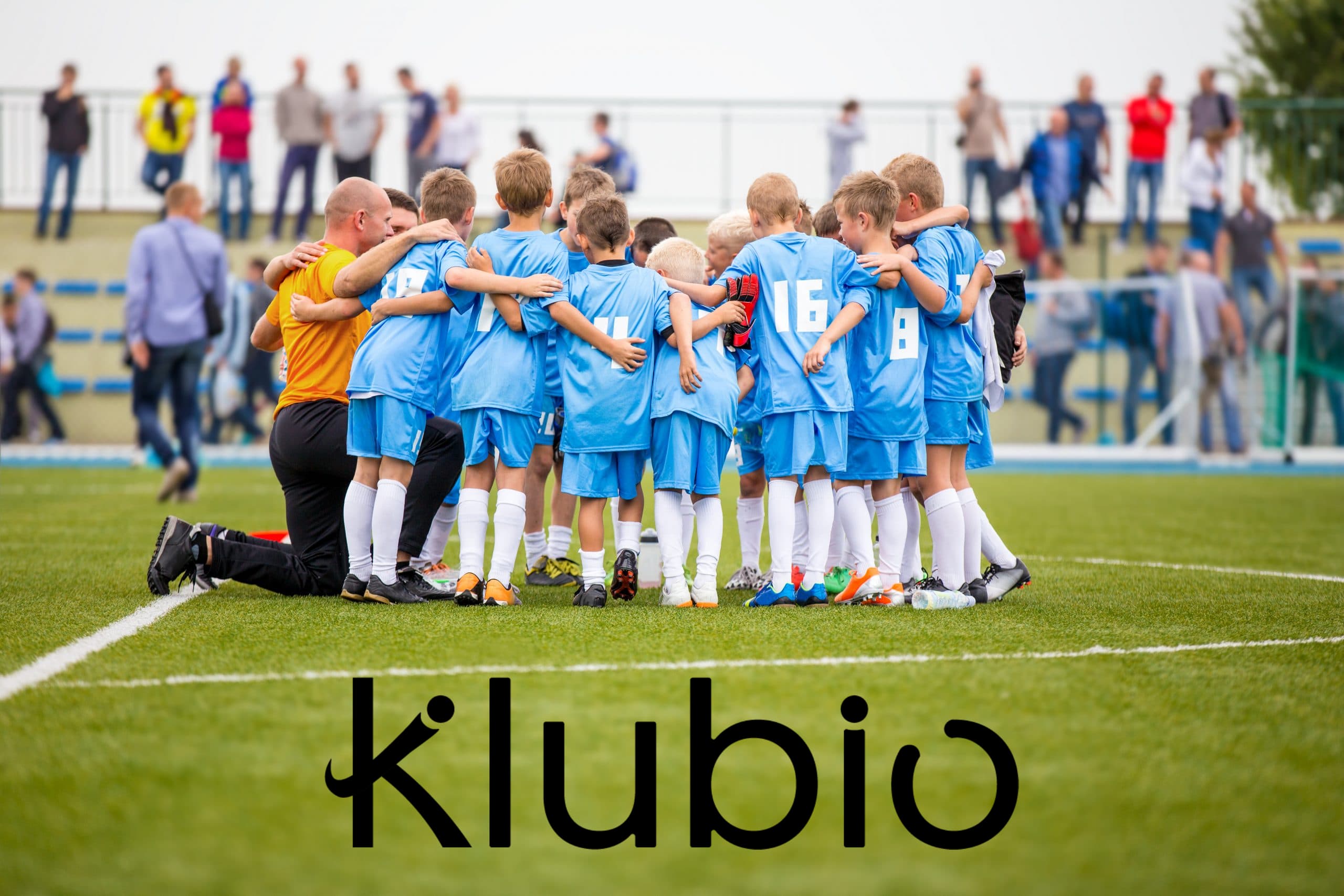 Coaches and young players together on the pitch